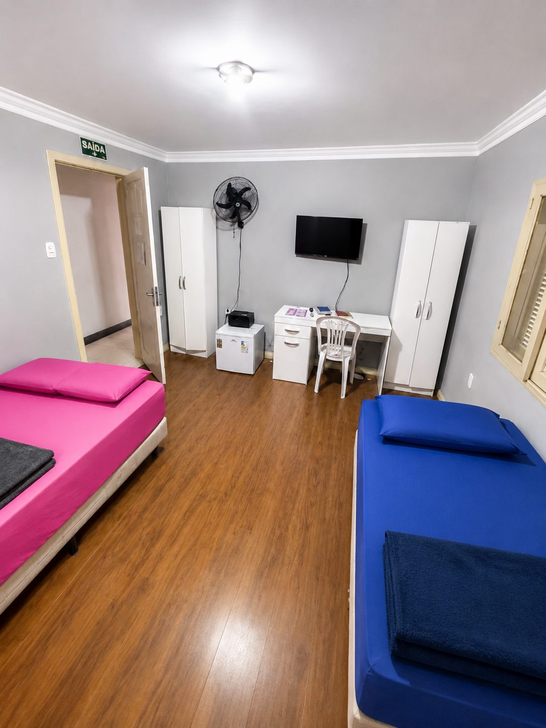 Quarto semiprivativo da ala feminina com TV e escrivaninha